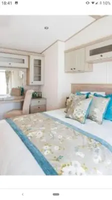 a bedroom with a large bed in a small room at Valley View with a luxurious hot tub in Newquay