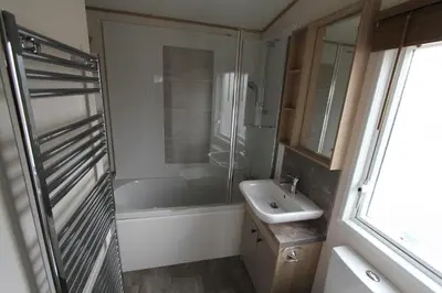 a bathroom with a tub and a sink and a shower at Valley View with a luxurious hot tub in Newquay