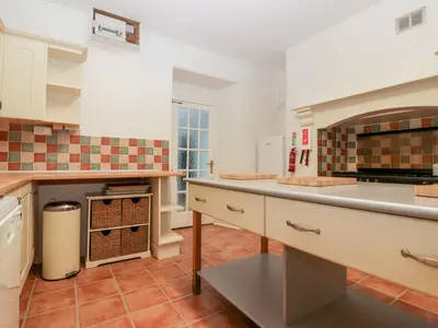 a kitchen with a counter and an oven in it at Trevena Lodge in Tintagel