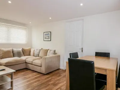 a living room with a couch and a table at Cove Cottage in Tintagel