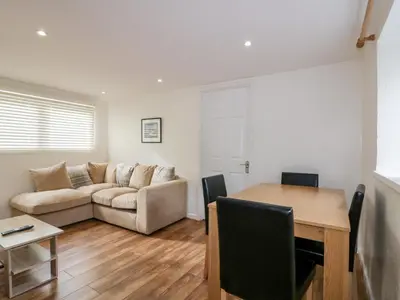 a living room with a couch and a table at Cove Cottage in Tintagel