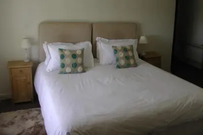 a white bed with two pillows on top of it at Lellizzick Farmhouse in Padstow