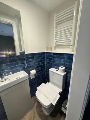 a bathroom with a toilet and a sink and a mirror at The London Inn in Padstow