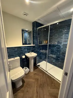 a bathroom with a toilet and a shower and a sink at The London Inn in Padstow