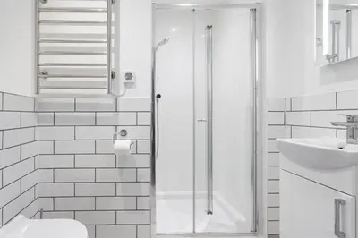 a bathroom with a shower and a toilet and a sink at The Olive Branch in St Ives