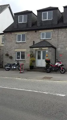 two motorcycles parked in front of a brick building at Thurlestone House in St Ives