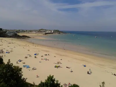 a group of people on a beach with the ocean at Thurlestone House in St Ives