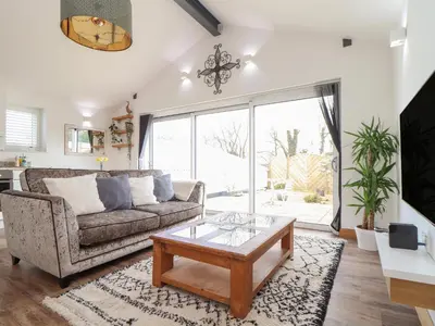 a living room with a couch and a coffee table at Chycoose in Truro