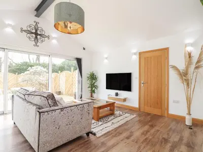a living room with a couch and a tv at Chycoose in Truro