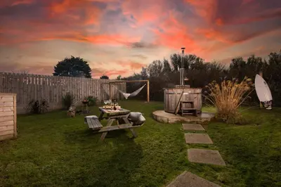 a backyard with a picnic table and a grill at Wheal Jewel- Beautifully Fitted Wooden Lodge Helston Cornwall in Helston