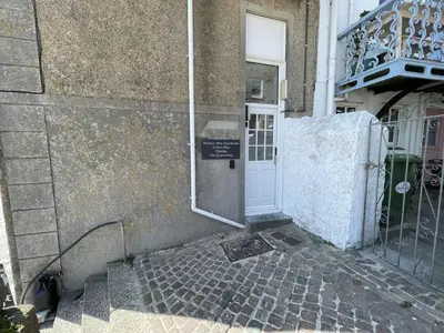 a door to a building with a sign on it at Crows Nest - panoramic views of St Ives harbour in St Ives