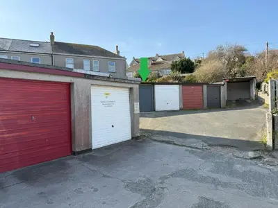 a row of garage doors in a parking lot at Crows Nest - panoramic views of St Ives harbour in St Ives