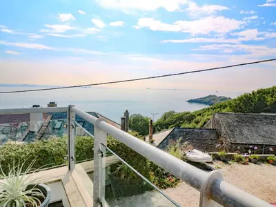 a view of the ocean from the balcony of a house at The Poop Deck in Helston