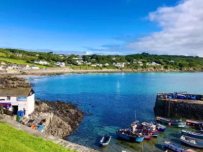 a group of boats docked in a body of water at The Poop Deck in Helston