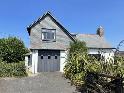 a gray and white house with a garage at Stratton Vow - a true 1920s Arts and Crafts house! in St Ives