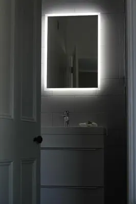 a bathroom with a sink and a mirror at The Five Pilchards Inn in Helston