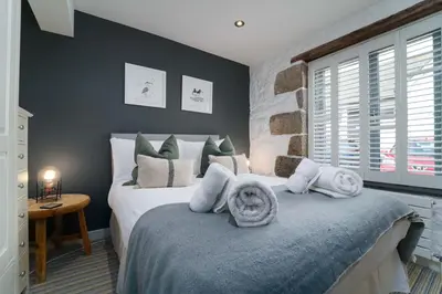 a bedroom with a large bed with white pillows at Island Wastrel in St Ives