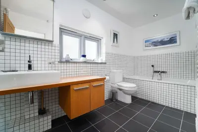a bathroom with a sink and a toilet and a tub at Island Wastrel in St Ives
