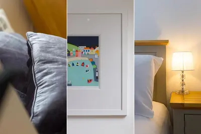 a bedroom with a bed and a picture on the wall at Little Gem in St Ives