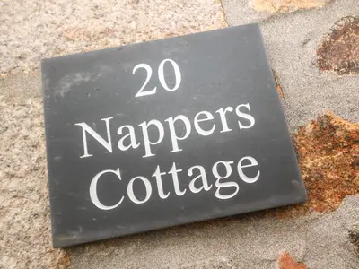 a sign that says papers conference on the sidewalk at Nappers Cottage in Hayle