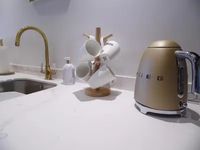 a blender sitting on a kitchen counter next to a sink at Beachside Apartment in Carbis Bay