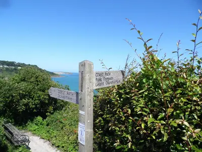 a wooden sign on the side of a trail at Beachside Apartment in Carbis Bay