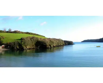an island in the middle of a body of water at Trelawne Garden Annexe in Falmouth
