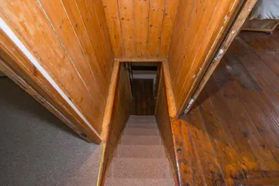 an overhead view of a staircase in a wooden ceiling at Jacobs Cottage in Port Isaac