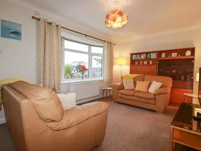 a living room with a couch and a chair at Garden View in Newquay
