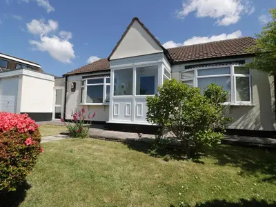 a bedroom house with a garden in front of it at Garden View in Newquay