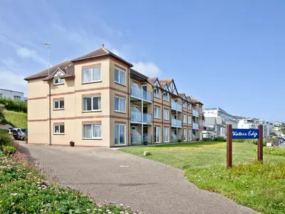 a building with a street sign in front of it at Apartment 2 Waters Edge in Crantock