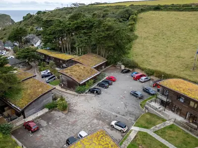 an aerial view of a parking lot with parked cars at Cornish Holiday - Bodannon in Porthtowan