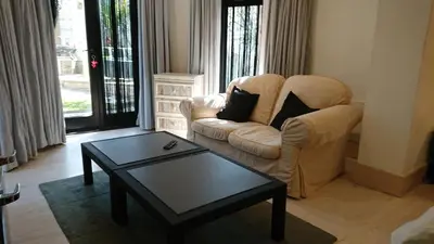 a living room with a chair and a coffee table at The Black Palms - Fistral Beach in Newquay