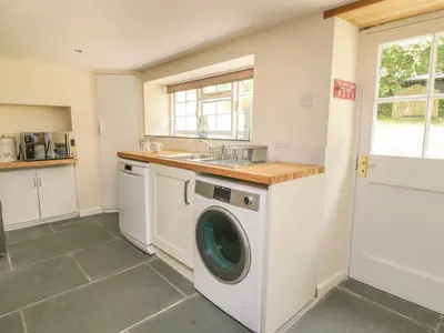 a kitchen with a washing machine and a sink at 9 Copes Gardens in Truro