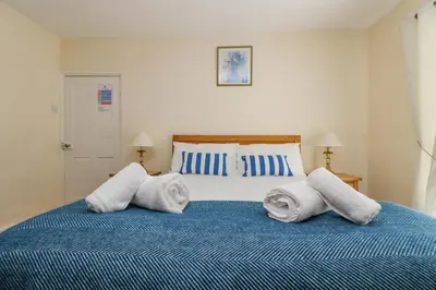 a bedroom with a bed with towels on it at 9 Copes Gardens in Truro