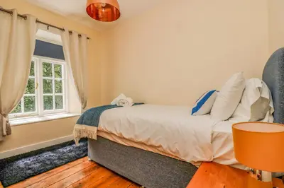a bedroom with a bed and a window at 9 Copes Gardens in Truro