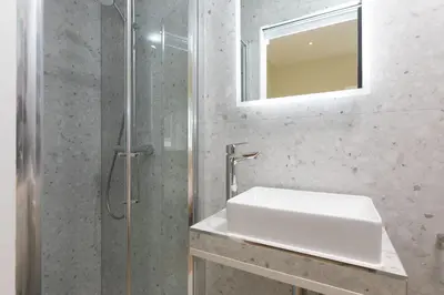 a bathroom with a sink and a shower at White Waves in St Ives