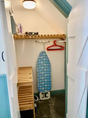 a play house with a surfboard and a shelf at Lynwood House Self Contained Studio in Tregoney