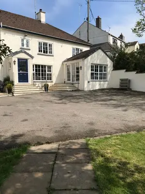 a large white house with a large driveway at Lynwood House Self Contained Studio in Tregoney