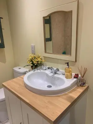 a bathroom with a white sink and a mirror at The Old Deer House in Bodmin