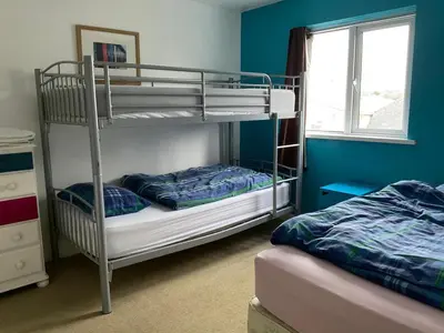 a bedroom with two bunk beds and a window at Blue Room Hostel Newquay in Newquay