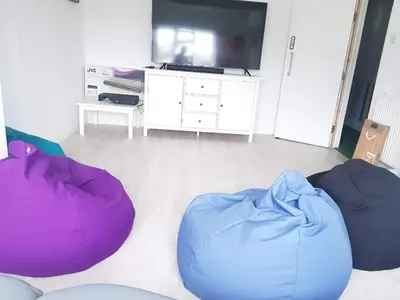a living room with two bean bags and a tv at Blue Room Hostel Newquay in Newquay
