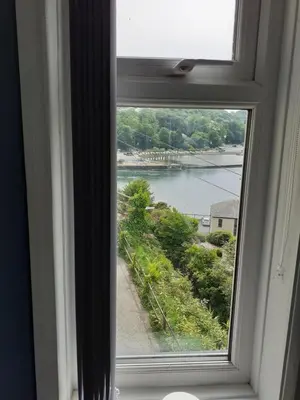 a window with a view of a body of water at Admirals Apartment 'As seen in Beyond Paradise ' sleeps 6 adults in Looe
