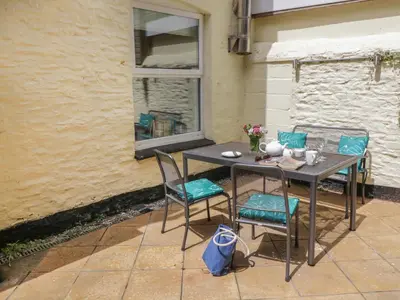 a table and chairs sitting on a patio at Pirate's Pad in St Austell