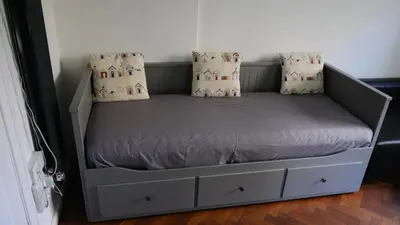 a bed with two pillows on it in a room at Commanders Cabin 'As seen in Beyond Paradise' in Looe
