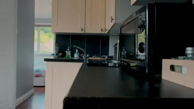 a kitchen with a black and white counter top at Captain's Quarters 'As seen in Beyond Paradise ' in Looe
