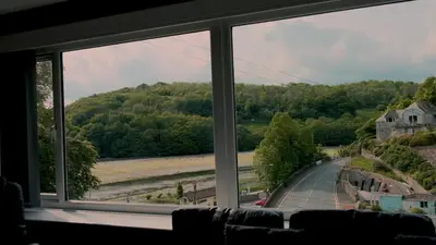 a view from a window of a road and trees at Captain's Quarters 'As seen in Beyond Paradise ' in Looe