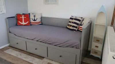 a bed with pillows on it in a bedroom at Bosons Bunks 'As seen in Beyond Paradise ' in Looe