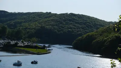 two boats on a river with a mountain at Bosons Bunks 'As seen in Beyond Paradise ' in Looe