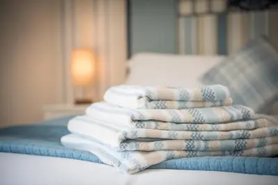 a stack of towels sitting on a table at Mandalay in Bude
